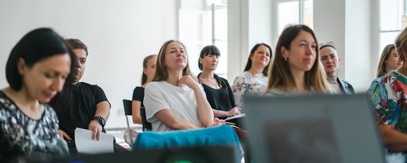Adults at a training workshop in a sunlit room